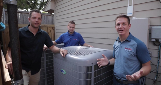three men next to two condensers