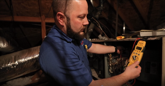 hvac technician inspecting home furnace