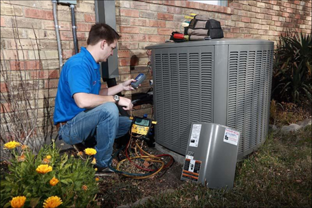 technician inspecting condenser
