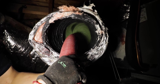 cleaning an air duct with a rotating brush