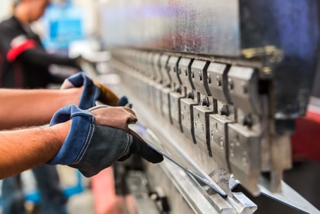 factory worker bending sheet metal