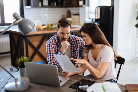 couple looking at high energy bills