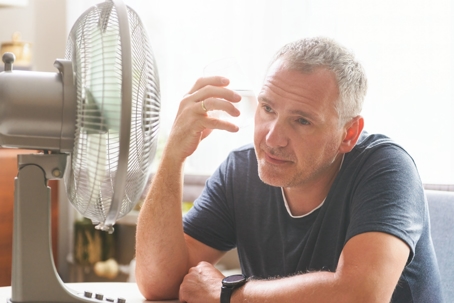man trying too cool off at home