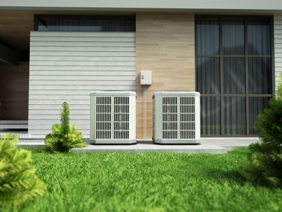 two heat pumps condensers outside a modern home