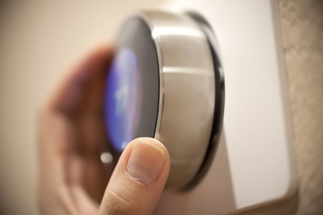 hand adjusting smart thermostat