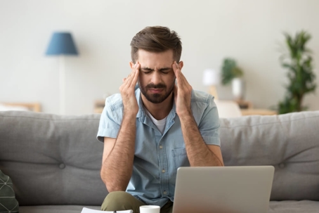 Homeowner sitting on couch feeling sick