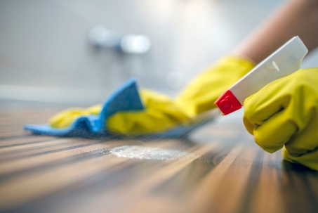 woman disinfecting table
