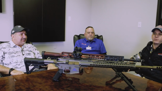 Tree men in front of a riffle